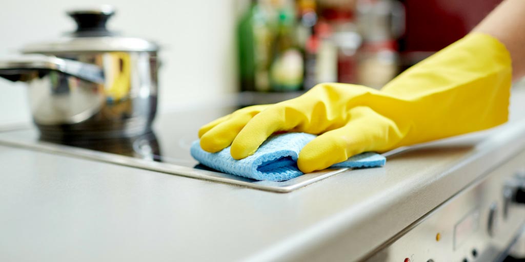 A pair of yellow gloves on top of a counter.